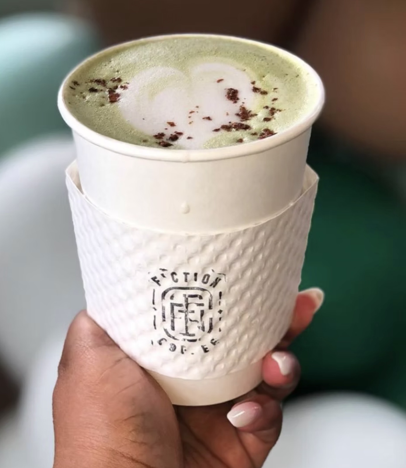 Matcha latte in a Fiction Coffee cup